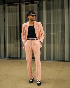Blush Pink Suit with Black T-Shirt and Two-Tone Loafers
