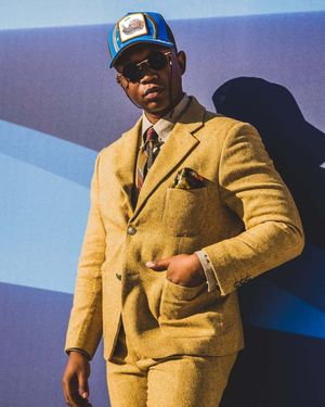 Golden Mustard Tweed Suit with Denim Shirt and Baseball Cap