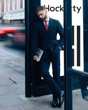 Navy Pinstriped Double-Breasted Suit with Red Striped Tie